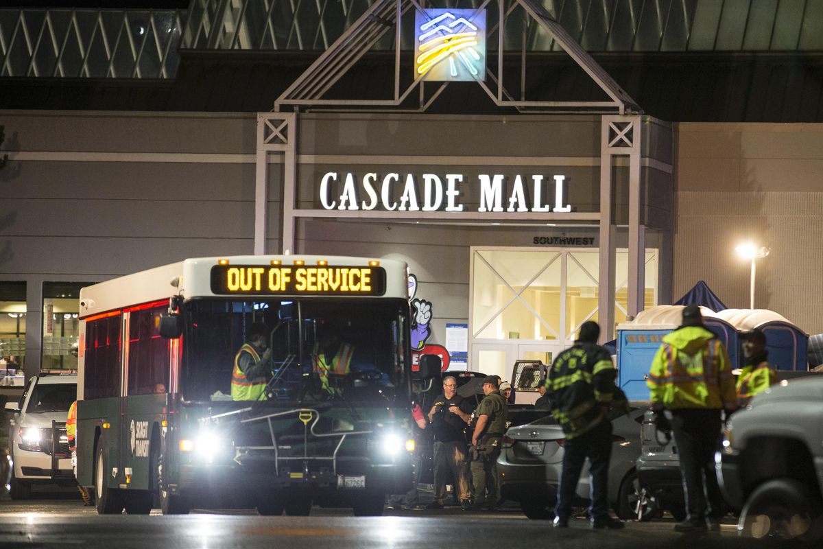 In this Sept. 23, 2016, file photo, emergency personnel stand in front of an entrance to the Cascade Mall at the scene of a shooting where five people were killed in Burlington, Wash. (Stephen Brashear / Associated Press)
