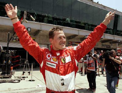 
Michael Schumacher celebrates after winning the pole position.
 (Associated Press / The Spokesman-Review)