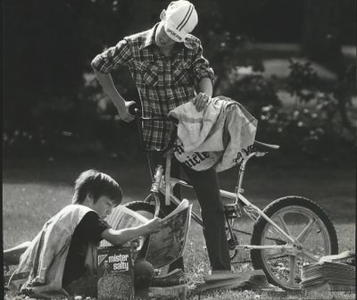FILE - Adam Lewis and Craig Peterson, Spokesman-Review newspaper carriers, are shown in this photo from 1985. (The Spokesman-Review)