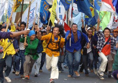 
Protesters march during a demonstration against the government's plan to raise fuel prices outside the presidential palace in Jakarta, Indonesia, Friday. Despite the protest, the plan went into effect today. 
 (Associated Press / The Spokesman-Review)