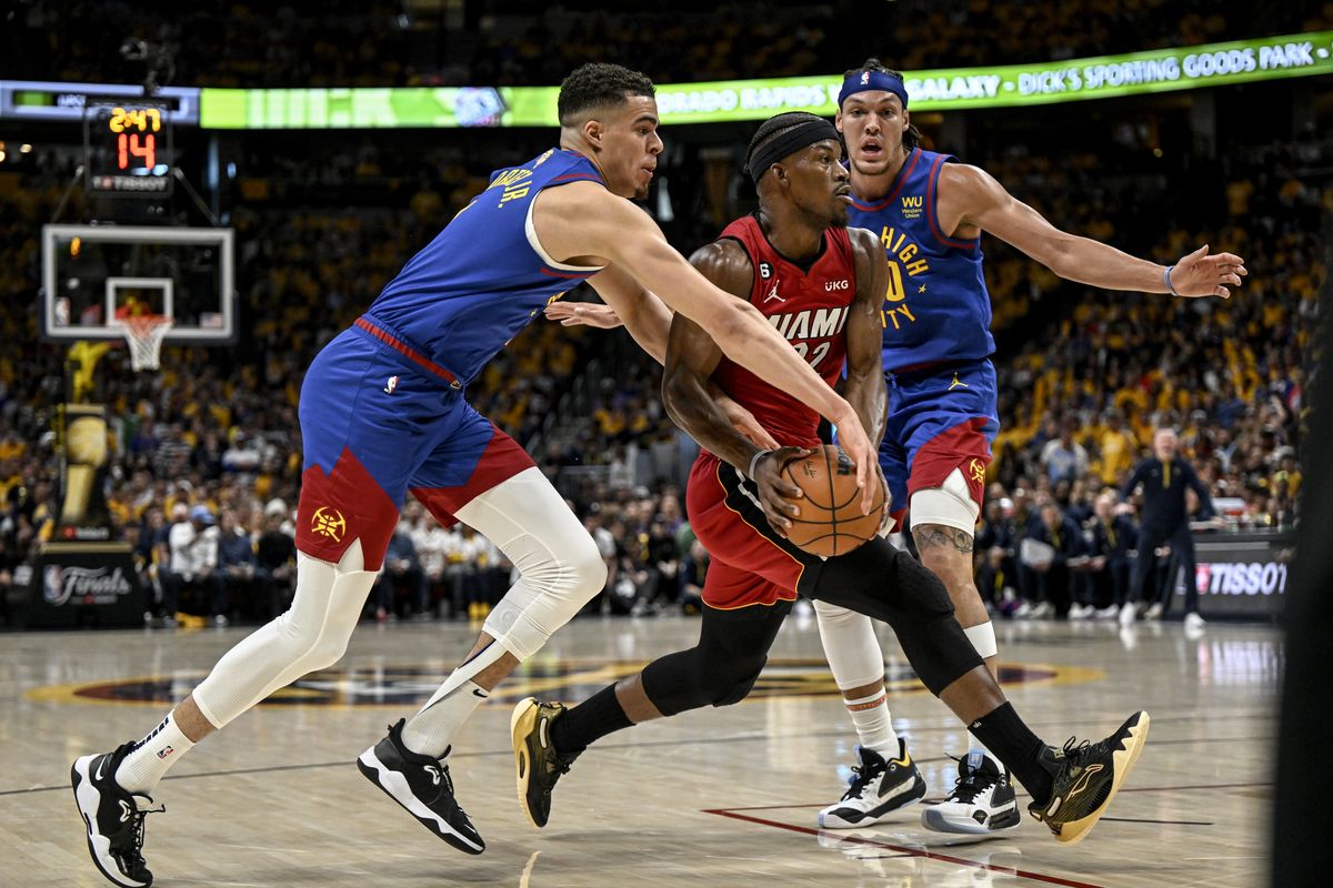 Miami’s Jimmy Butler, held to 13 points Thursday, drives between Denver’s Michael Porter Jr., left, and Aaron Gordon during Game 1 of the NBA Finals in Denver.  (AAron Ontiveroz)