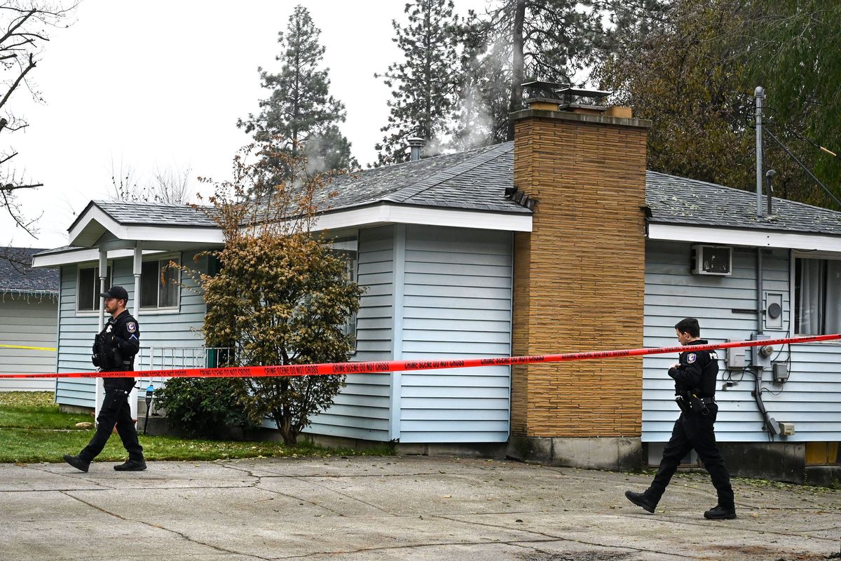 Spokane police were on the scene Friday in northwest Spokane, where a woman and two children were found dead late Thursday on the 2600 block of West Woodside Avenue.  (DAN PELLE/THE SPOKESMAN-REVIEW)