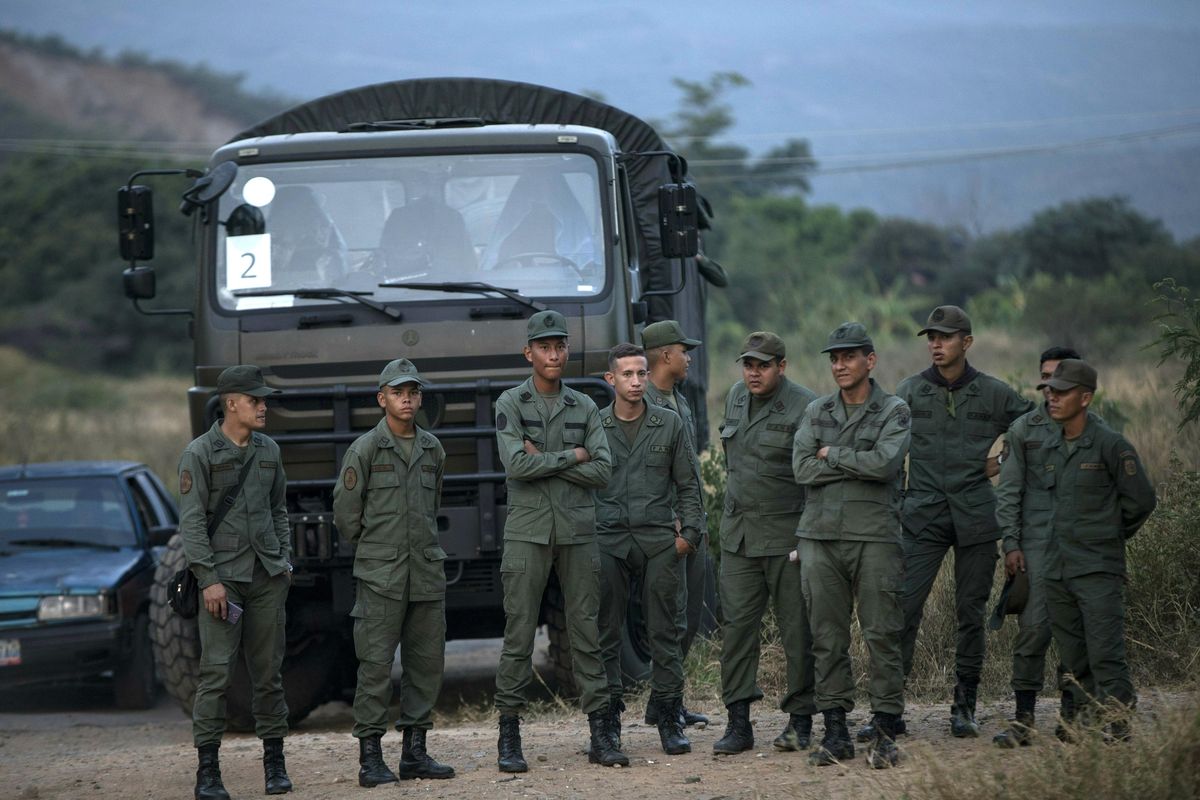 Soldiers stand at the entrance of the Tienditas International bridge that connects Venezuela with Colombia, in Urena, Venezuela, Thursday, Feb. 21, 2019. Heightened tensions in Venezuela left a woman dead and a dozen injured near the border with Brazil on Friday. (Rodrigo Abd / AP)