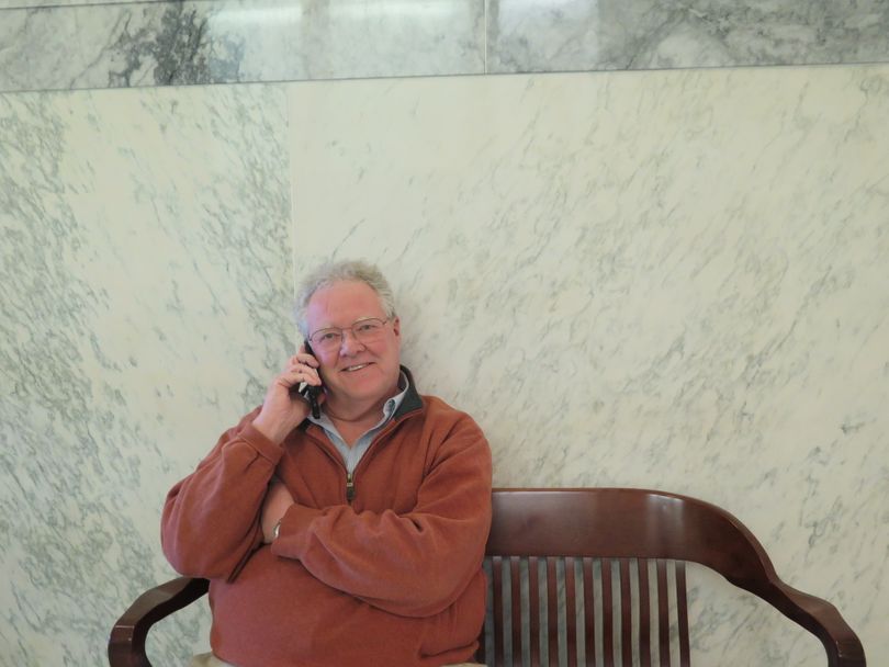 Former state Rep. John Rusche, D-Lewiston, talks on the phone outside the Idaho Secretary of State's office on Friday, March 9, 2018, after filing to run again for his old seat. (Betsy Z. Russell)