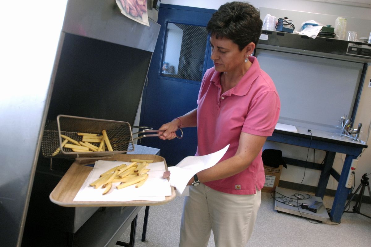 University of Idaho research scientist Tina Brandt prepares a fresh batch of french fries in the laboratory at the University of Idaho Kimberly Research Center outside Kimberly, Idaho.  (Associated Press / The Spokesman-Review)