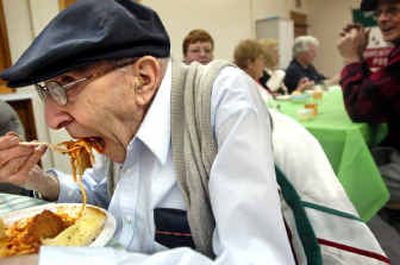 
American-Italian Club member Charley Vingo, 97, digs in to a plate of spaghetti during the Post Falls Sons of Italy spaghetti feed held at St. George's Catholic Church on Saturday afternoon. The spaghetti feed event was a first for the Post Falls group, which was founded in June 2004. 
 (Holly Pickett / The Spokesman-Review)