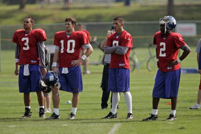 David Carr, with arms folded, is trying to find his place among New York Giants QBs.  (Associated Press / The Spokesman-Review)
