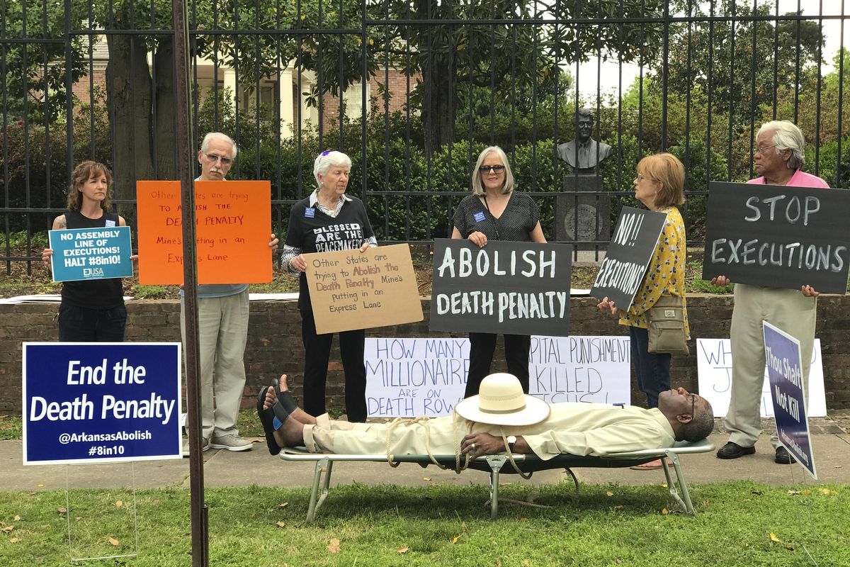 Pulaski County Circuit Judge Wendell Griffen taking part of an anti-death penalty demonstration outside the Governor's Mansion Friday, April 14, 2017 in Little Rock, Ark. Griffen issued a temporary restraining order Friday blocking the state from using its supply of vecuronium bromide after a company said it had sold the drug to the state for medical purposes, not capital punishment. Local media outlets had tweeted photos and video of Griffen appearing to mimic an inmate strapped to a gurney at the demonstration. Attorney General Leslie Rutledge's office said she planned to file an emergency request with the state Supreme Court to vacate Griffen's order, saying Griffen shouldn't handle the case. (Sherry Simon via Associated Press)