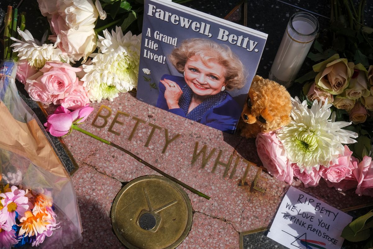 Flowers, stuffed toys and cards are displayed at the Hollywood Walk of Fame star of the late actress Betty White on Dec. 31 in Los Angeles. White, whose saucy, up-for-anything charm made her a television mainstay for more than 60 years, whether as a man-crazy TV hostess on “The Mary Tyler Moore Show” or the loopy housemate on “The Golden Girls,” died Dec. 31. She was 99.  (Associated Press)