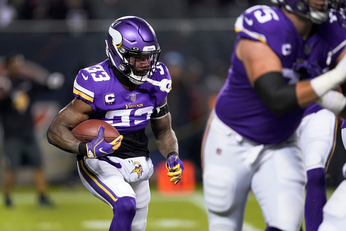 Minnesota Vikings running back Dalvin Cook carries the ball during the first half of an NFL football game against the Chicago Bears Monday, Dec. 20, 2021, in Chicago.  (David Banks)