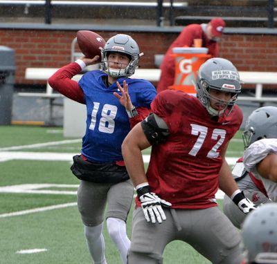 Washington State quarterback Anthony Gordon unleashes a pass as Abraham Lucas blocks during a practice Saturday in Pullman. (Rod Commons/Washington State Athletics)