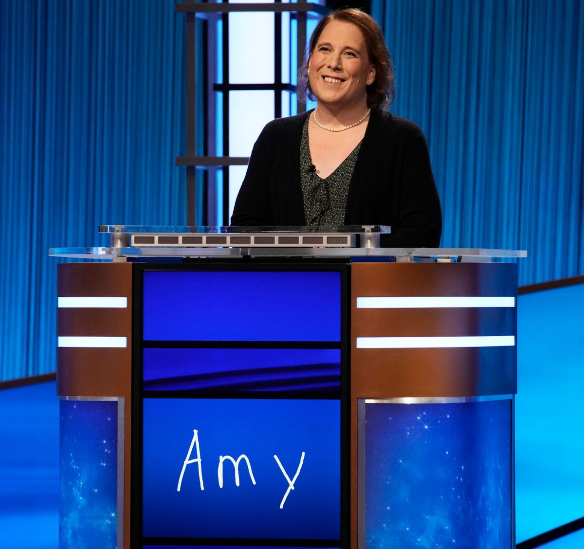 Amy Schneider stands on the set of “Jeopardy!”  (HONS)