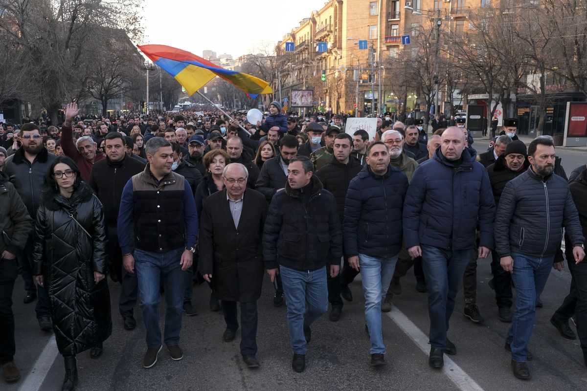 Opposition demonstrators march to the government buildings during a rally to pressure Armenian Prime Minister Nikol Pashinyan to resign in Yerevan, Armenia, Saturday, Feb. 27, 2021. The developments come after months of protests sparked by the nation