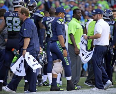 Seahawks quarterback Russell Wilson (3) walks along the sideline with an ice pack wrapped on his left knee against the San Francisco 49ers in the second half of an NFL football game, Sunday, Sept. 25, 2016, in Seattle. (Ted S. Warren / Associated Press)
