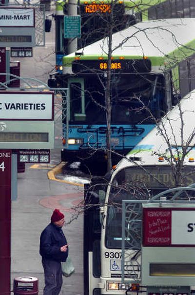 
A rider negotiates the curbside choices at the STA Plaza in downtown Spokane in February. 
 (Jesse Tinsley / The Spokesman-Review)