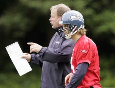 
Associated Press Seattle coach Mike Holmgren, with quarterback Derek Devine, spiced up minicamp by installing new plays.
 (Associated Press / The Spokesman-Review)