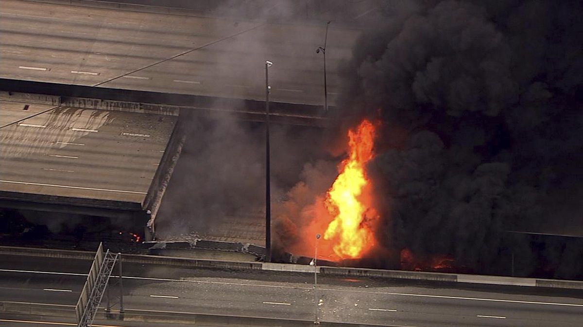 In this aerial image made from a video provided by WSB-TV, a large fire that caused an overpass on Interstate 85 to collapse burns in Atlanta, Thursday. Witnesses say troopers were telling cars to turn around on the bridge because they were concerned about its integrity. Minutes later, the bridge collapsed. (WSB-TV via Associated Press)