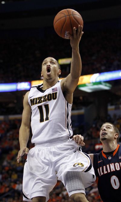 Michael Dixon, left, came off the bench Thursday to score 18 points for No. 9 Missouri in a 78-74 win over No. 25 Illinois. (Associated Press)