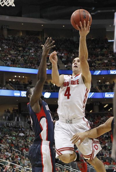 Ohio State's Aaron Craft (4) puts up a shot in front of Gonzaga's Guy Landry Edi in the second half of an E NCAA tournament third-round college basketball game on Saturday in Pittsburgh. Ohio State won 73-66. (Associated Press)