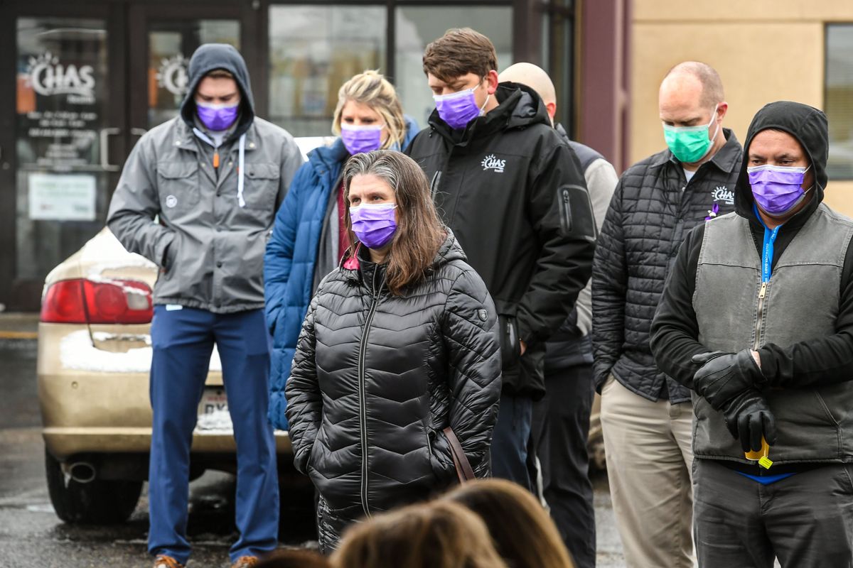 The Spokane community gathers and listens in silence during a memorial service as the names of 162 homeless people who passed away in 2021 are read aloud at the CHAS Denny Murphy Clinic, Tuesday, Dec. 21, 2021 in Spokane.  (DAN PELLE/THE SPOKESMAN-REVIEW)