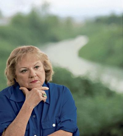 This July 2004 file photo shows, true-crime author Ann Rule, who wrote a book about serial killer Gary Ridgway, who left some of his victims’ bodies along the Green River outside Seattle, Wash., shown in the background. Rule, who wrote more than 30 books, including a profile of her former co-worker, serial killer Ted Bundy, has died at age 83. Scott Thompson, a spokesman for CHI Franciscan Health, said Rule died at Highline Medical Center at 10:30 p.m. Sunday, July 26, 2015.  (Betty Udeson photo)