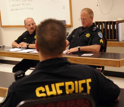 Sgt. Don Manning, left, and Sgt. Doug Lawson at shift change and the 5:30 p.m. roll call (J. BART RAYNIAK)