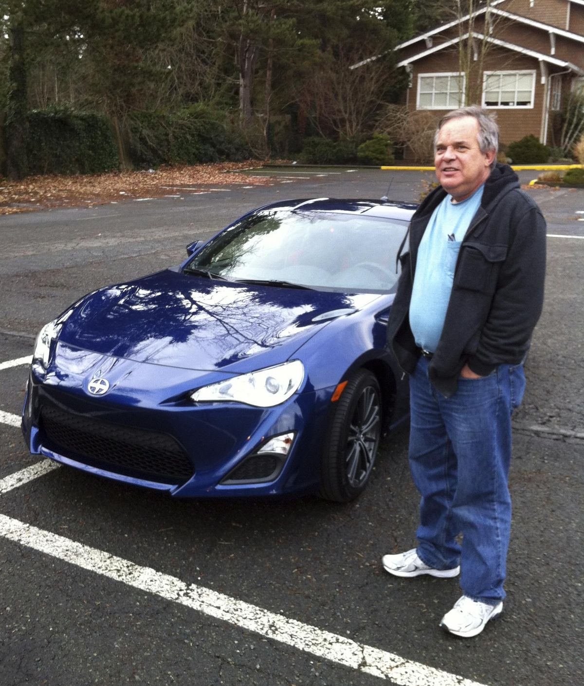 In this Dec. 14, 2013, photo provided by Shashi Karan, Alan Naiman poses with his new car, an unusual extravagance for him, in Seattle. When Naiman, a Washington state social worker, died this year of cancer at the age of 63, the generous loner left most of his surprise estate worth $11 million to children’s charities helping the poor, sick, disabled, abandoned and those otherwise stuck in foster care, unbeknownst to those beneficiaries or his own loved ones. (Shashi Karan / AP)