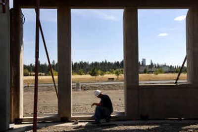 
Laborer Andrey Lopachuk patches concrete at the new Divcon Inc. building in the Pinecroft Business Park in Spokane Valley. 
 (Holly Pickett / The Spokesman-Review)