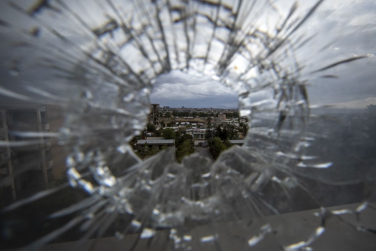 FILE - In this Thursday, May 6, 2021 file photo, the city of Mekele is seen through a bullet hole in a stairway window of the Ayder Referral Hospital, in the Tigray region of northern Ethiopia. Ethiopia