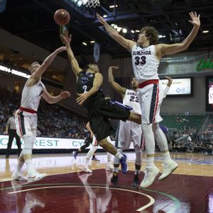 Gonzaga forward Domantas Sabonis, left,  and  forward Kyle Wiltjer, right,  compete for a rebound with Portland guard Alec Wintering  during the first half Saturday. (Colin Mulvany / The Spokesman-Review)