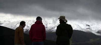 
Volcano watchers are silhouetted against the snow-covered flanks of Mount St. Helens as dark clouds hover near the summit as seen from Coldwater Ridge Visitors Center in southwest Washington on Monday.  Winter has hit the area hard the last few days, bringing heavy winds, rain and snow. 
 (Associated Press / The Spokesman-Review)