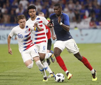 France’s Paul Pogba, right, battles for the ball with United States’ Will Trapp, left, and Weston McKennie during a friendly soccer match between France and USA at the Groupama stadium in Decines, near Lyon, central France, Saturday, June 9, 2018. (Laurent Cipriani / Associated Press)