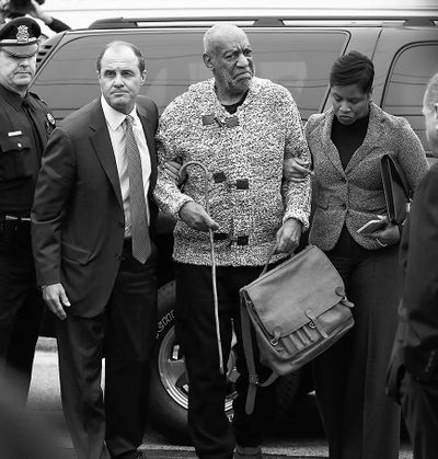 Actor and comedian Bill Cosby is helped as he arrives for a court appearance Wednesday in Elkins Park, Pa. Cosby was arrested and charged with drugging and sexually assaulting a woman at his home in  2004.