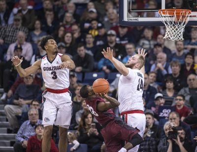 Gonzaga center Przemek Karnowski and Johnathan Williams, left, pressure LMU guard Brandon Brown, Jan. 12, 2107, in the McCarthey Athletic Center. (Dan Pelle / The Spokesman-Review)