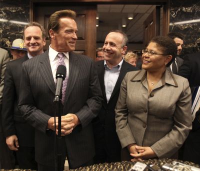 Gov. Arnold Schwarzenegger smiles at Senate President Pro Tem Darrell Steinberg, D-Sacramento, second from right, and Assembly Speaker Karen Bass, D-Los Angeles, after emerging from his office to announce an agreement has been reached Monday to solve California’s budget problem.   (Associated Press / The Spokesman-Review)