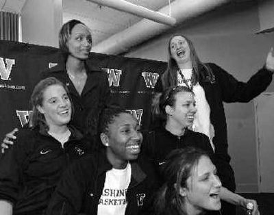 
New Washington women's basketball coach Tia Jackson, upper left, poses with players for a photo following a news conference. 
 (Associated Press / The Spokesman-Review)