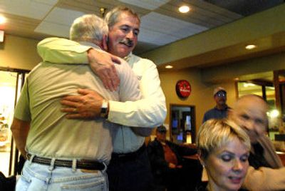 
Jim Hammond of Post Falls, center/facing, hugs friend Skip Hissong as early returns show him comfortably leading his opponent for the state legislature Tuesday night at Red Lion Templin's Hotel. 
 (Jesse Tinsley / The Spokesman-Review)