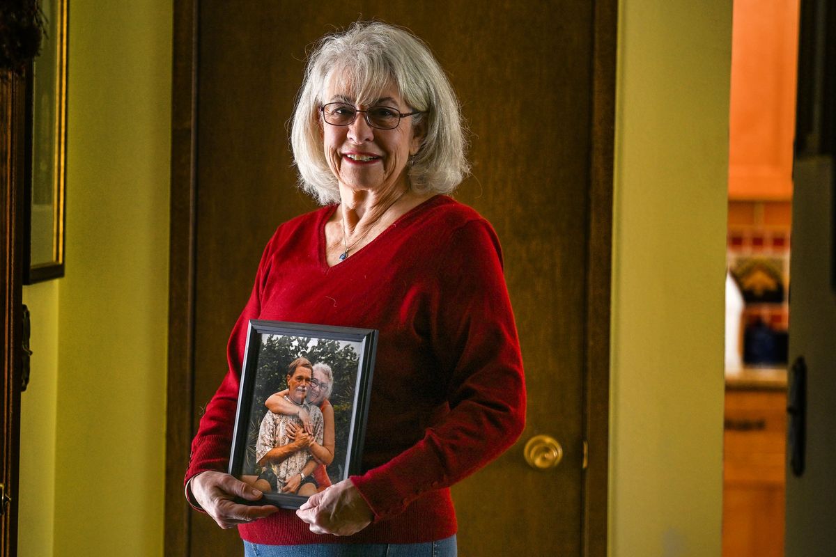 Cindy McMullen holds a photograph of her husband Dennis McMullen at her home Friday in Spokane Valley. Dennis, who competed in 49 Bloomsdays, died last year.  (Kathy Plonka/The Spokesman-Review)