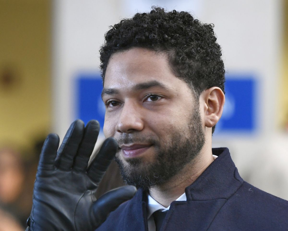 FILE - In this March 26, 2019, file photo, actor Jussie Smollett smiles and waves to supporters before leaving Cook County Court after his charges were dropped in Chicago. A special prosecutor in Chicago says Cook County State