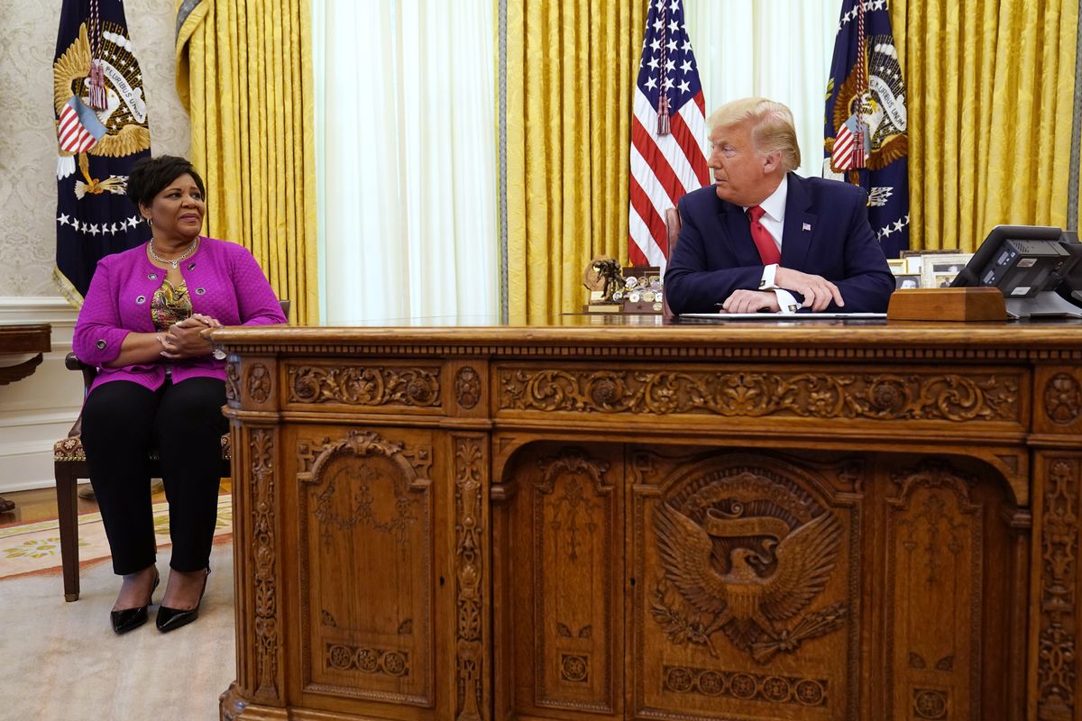 President Donald Trump speaks with Alice Marie Johnson as he issues a full pardon for Johnson in Oval Office of the White House on Friday, Aug. 28, 2020.  (Evan Vucci/Associated Press)