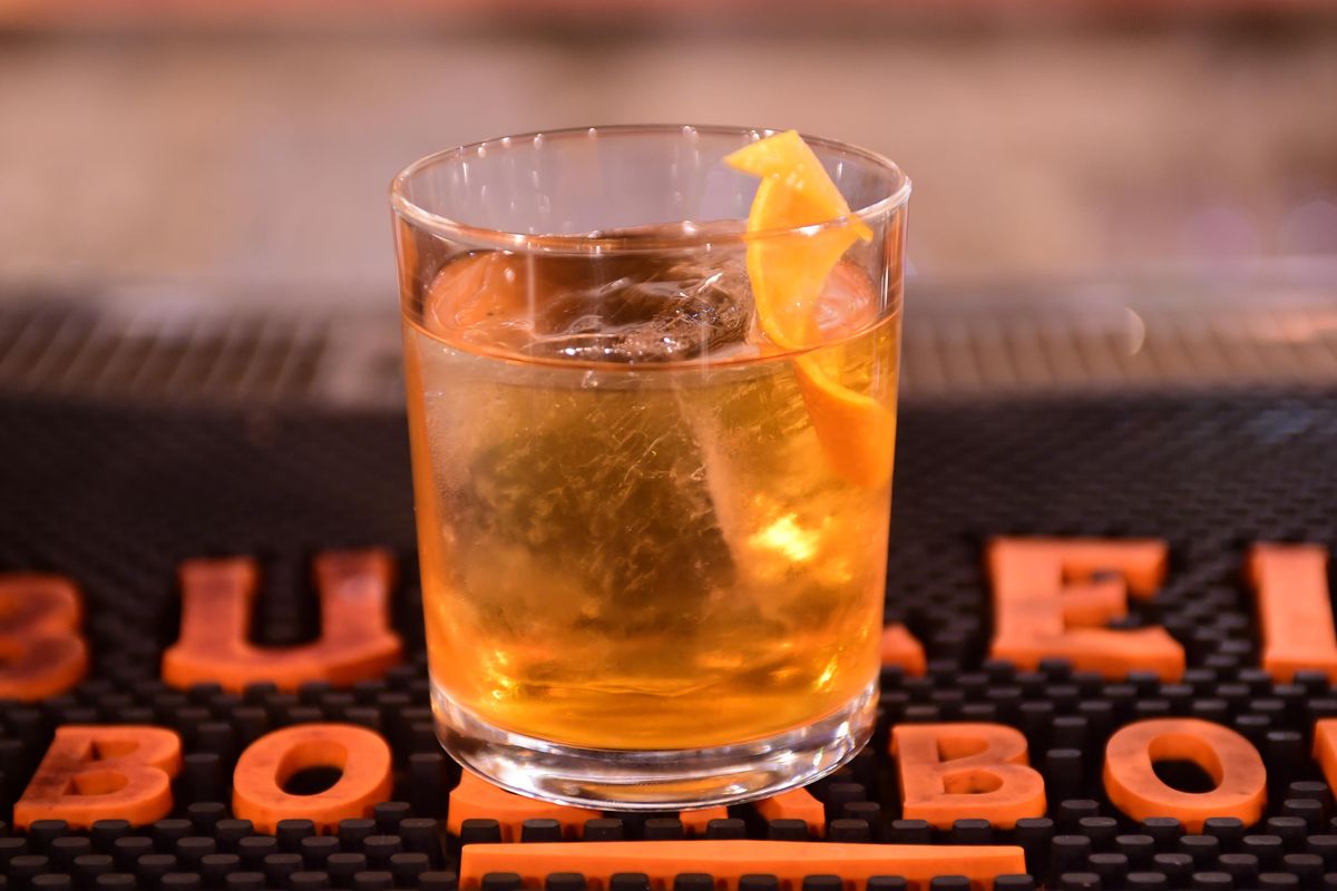 Simon Moorby, bartender at Hogwash Whiskey Den in the Washington Cracker Building, says the old-fashioned is the classic American cocktail because it combines bourbon or whiskey with various flavors to create the perfect taste. Photographed Monday, May 8, 2017. (Jesse Tinsley / The Spokesman-Review)