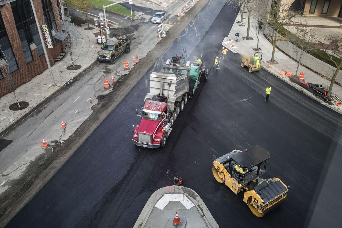 Inland Asphalt crews lay down a new surface on Monroe Street at Riverside Avenue, Oct. 19, 2016, in downtown Spokane. (Dan Pelle / The Spokesman-Review)