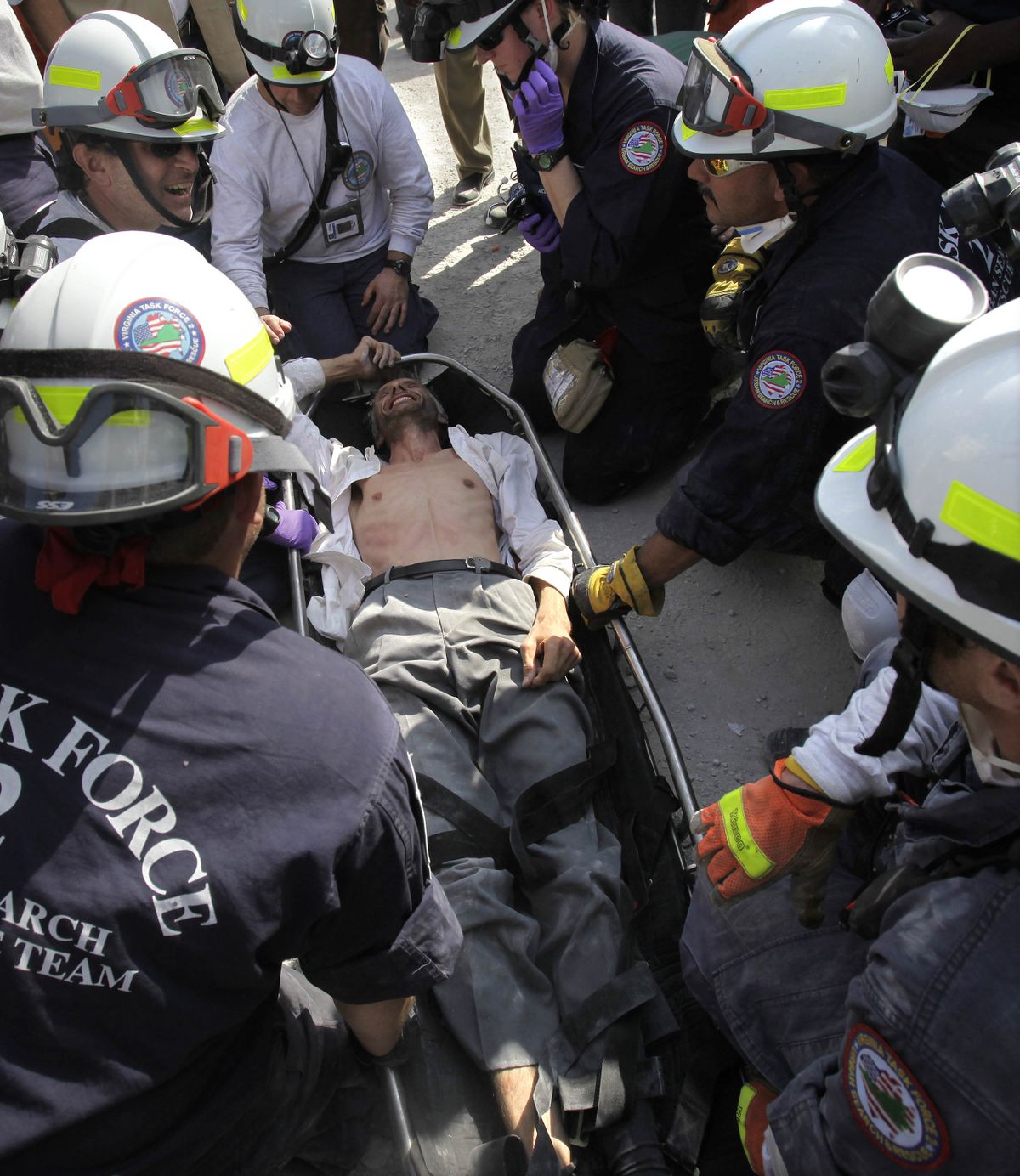 Search and rescue personnel tend to Jens Christensen, a United Nations worker from Denmark, who managed a smile shortly after being pulled from the rubble of the collapsed U.N. headquarters building Sunday. Associated Press photos (Associated Press photos)