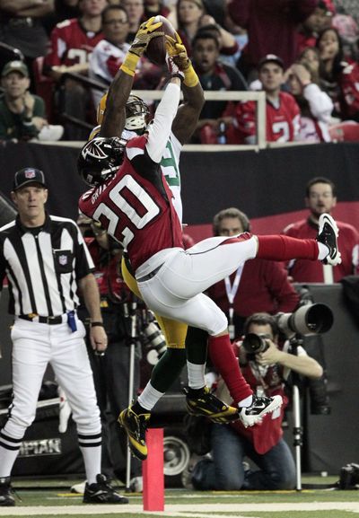 Packers wide receiver James Jones, background, catches a 20-yard touchdown pass. (Associated Press)