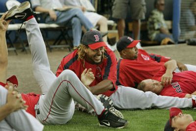 
If you take your cue from professional athletes, stretch. Boston Red Sox left fielder Manny Ramirez clowns around while stretching with teammates before a pregame workout. If you are exercising for general fitness, use the checklist below to perform a flexibility routine. 
 (AP / The Spokesman-Review)