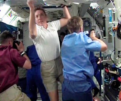 In this image from NASA TV, space shuttle mission specialist Heidemarie Stefanyshyn-Piper makes her way onto the International Space Station after docking Sunday.  (Associated Press / The Spokesman-Review)