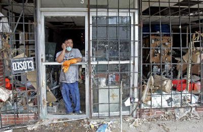 Tuan Nguyen takes a break from cleaning out his brother's hardware store in Biloxi, Miss. The store was heavily damaged by Hurricane Katrina more than a month ago.
(Associated Press / The Spokesman-Review)