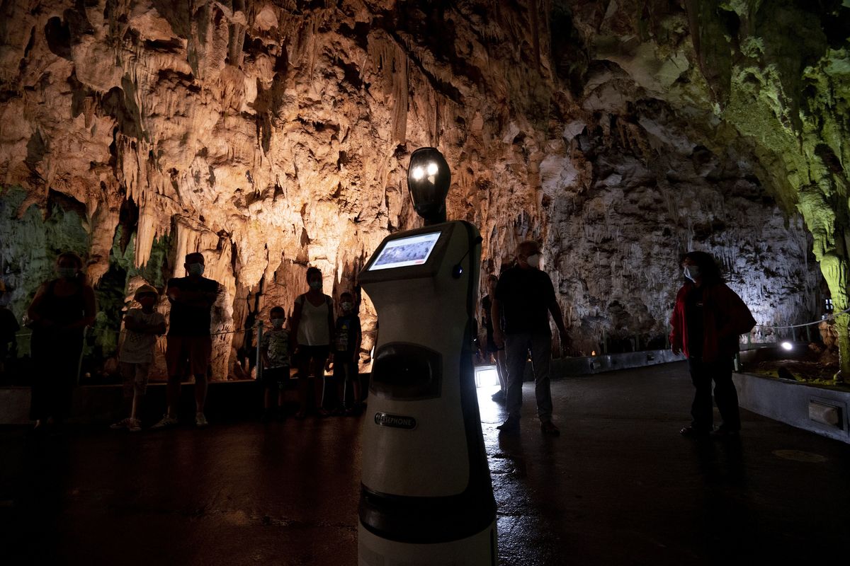 Persephone guides the visitors inside Alistrati cave, about 84 miles northeast of Thessaloniki, Greece, on Aug. 2. (Giannis Papanikos)
