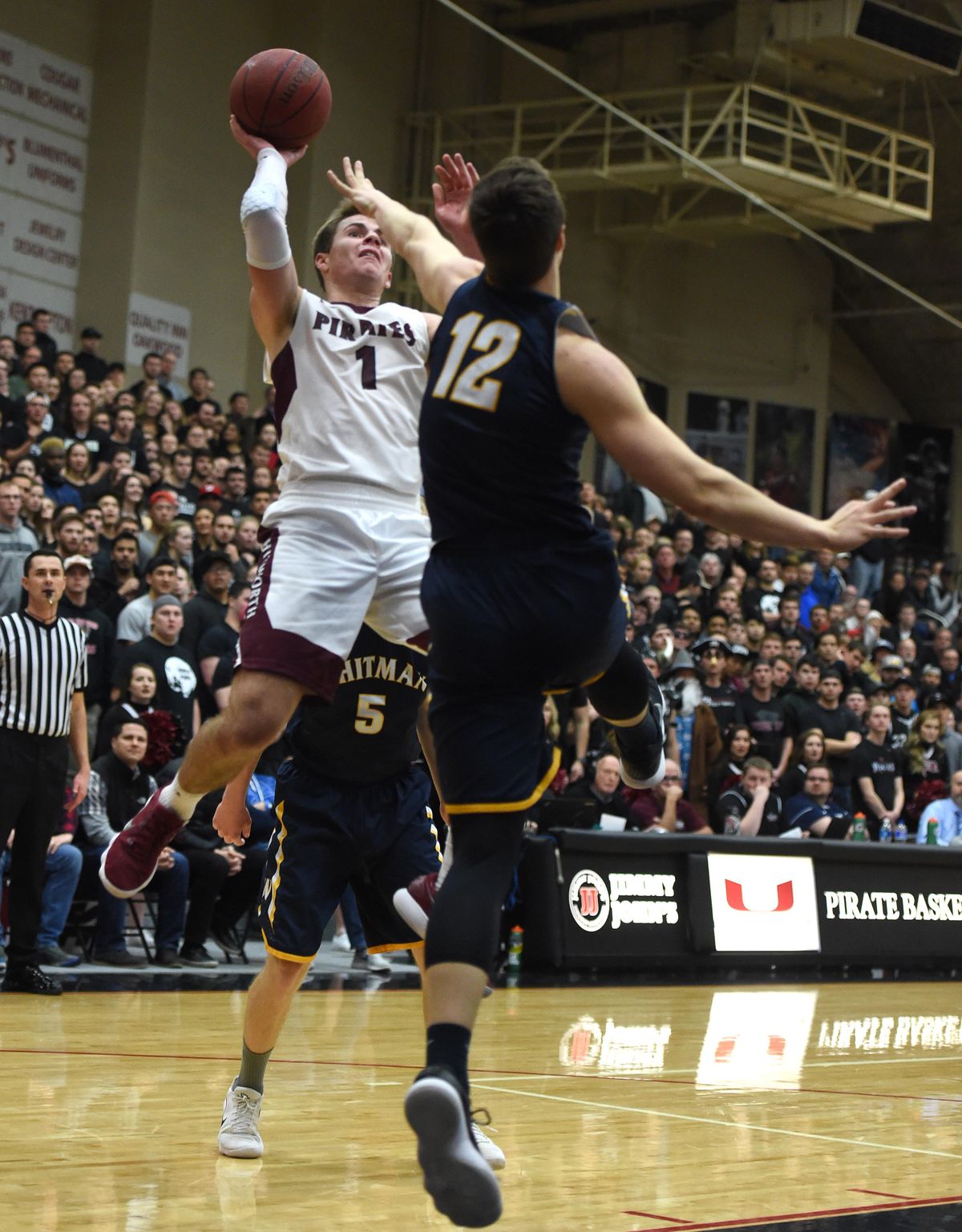 Whitworth guard Kyle Roach (1) takes a shot over Whitman’s Robert Colton (12) during the first half of a Division III college basketball game, Tues., Feb. 6, 2018, at Whitworth University. (Colin Mulvany / The Spokesman-Review)