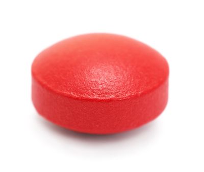 Red pills on a white background, isolated  (Shutterstock)